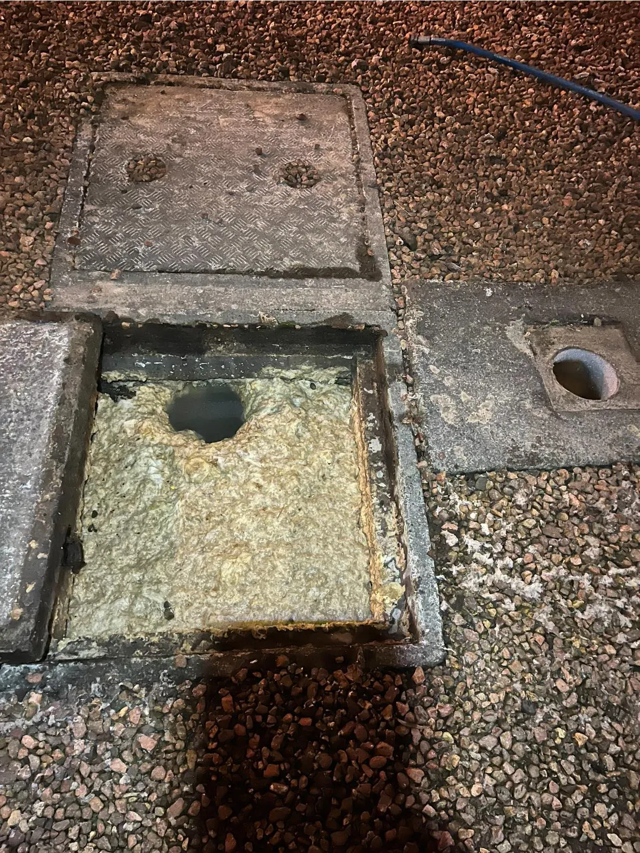 Severely blocked sewer manhole filled with fat, oil, and grease requiring expert unblocking.