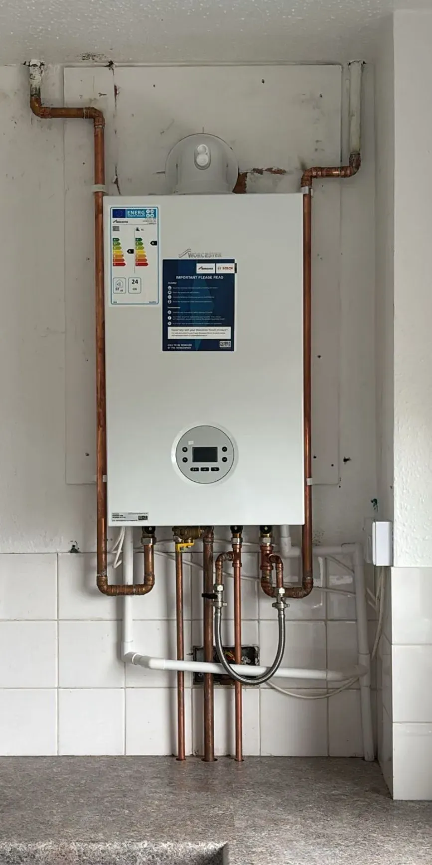 A newly installed or serviced boiler with copper pipes